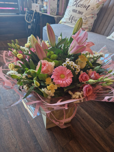 Ashleigh - A budding delight, complimented by greenery and presented in a gift box/bag. Beautiful flower bouquet hand delivered by the local florist.