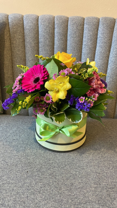 Simply The Best - A beautiful hat-box filled with a vibrant collection of flowers and foliage.