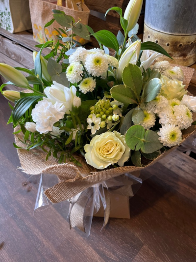 Evelyn - A fabulous collection of white and cream flowers make this the perfect gift. This bouquet will be hand delivered by the local florist.