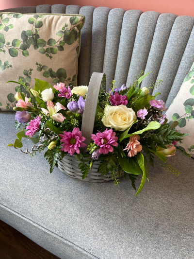 Bon Bon - Shower them with love with this cutesy collection of seasonal flowers in pretty pastels. Beautifully arranged and stylishly presented in a traditional basket.