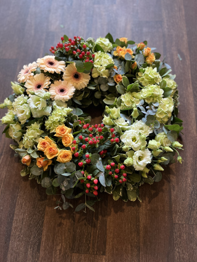 Eco Wreath SYM-354 - This open style wreath is designed on a biodegradable eco base. Made to order by our skilled florists, let us know what colour combination you would prefer, and we’ll select the best available flowers.