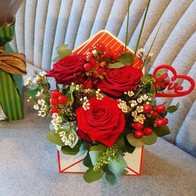 Love Letter - Send a message straight from your heart with this delightful envelope arrangement of romantic flowers